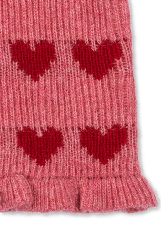 Laula Sweater Heart – detal dolnej części różowej dzianiny, czerwonych serc i wykończenia brzegu swetra.