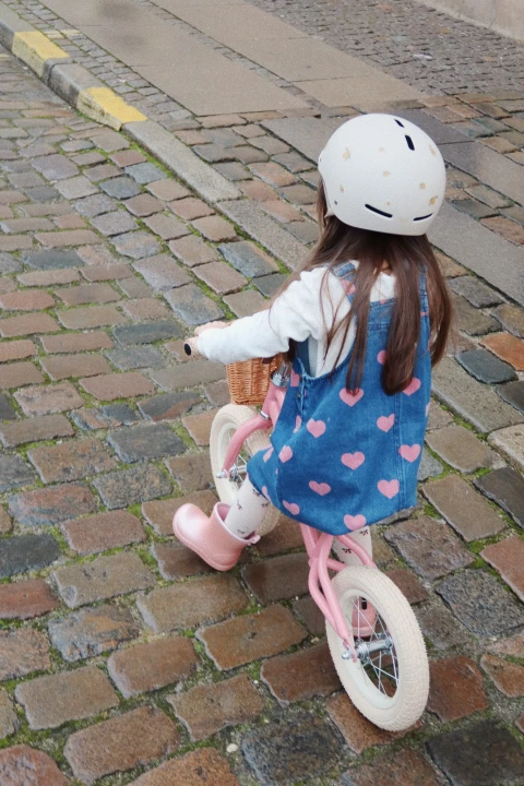 Dziecko jedzie na rowerze biegowym Sparkling Pink, widok od tyłu