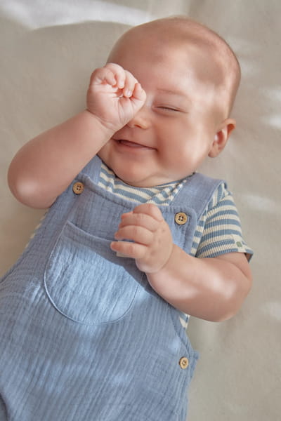 Body z krótkim rękawem w niebieskie paski na niemowlęciu w zbliżeniu