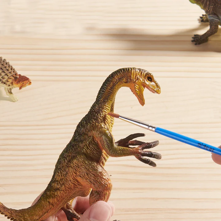 Dziecko bawiące się figurką drapieżnego dinozaura Mideer