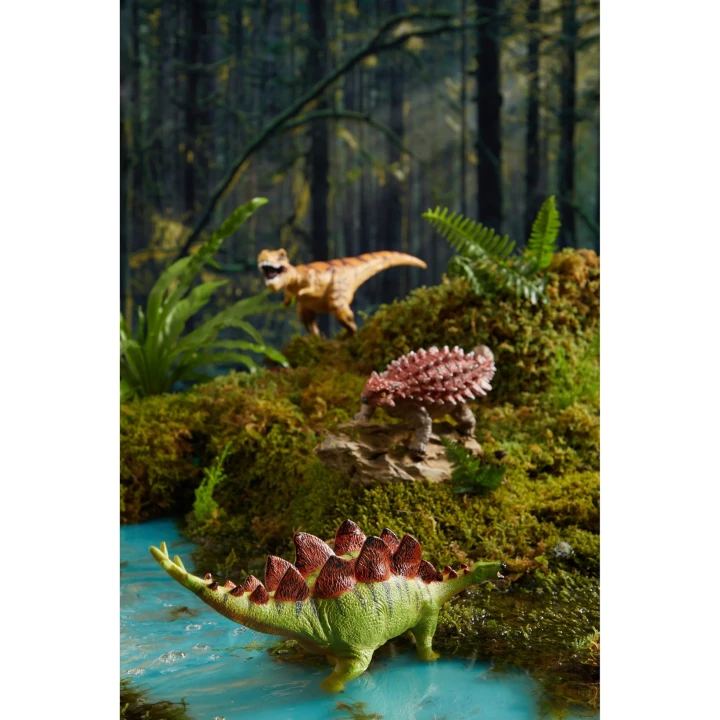 Figurki prehistorycznych zwierząt w leśnej scenerii do kreatywnej zabawy
