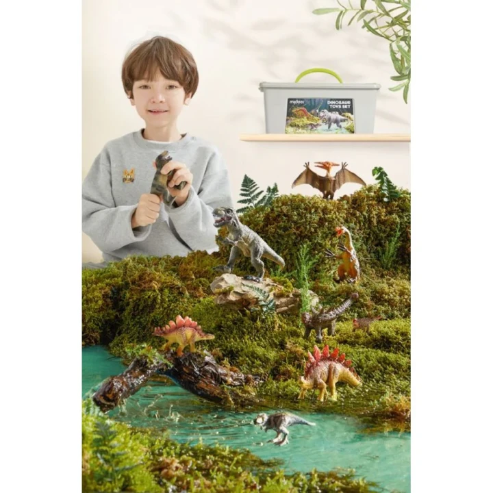 Dziecko bawiące się figurkami dinozaurów w prehistorycznej scenerii