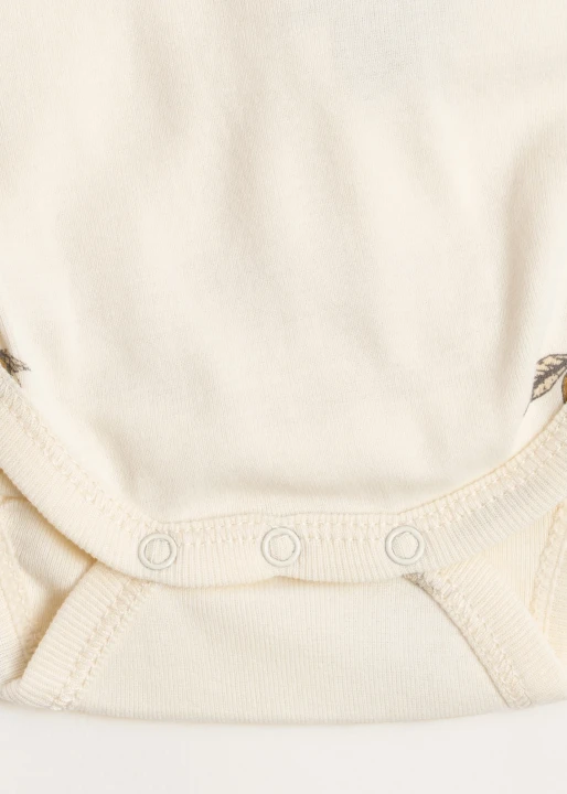 Newborn Body Lemon – detal kopertowego zapięcia body niemowlęcego